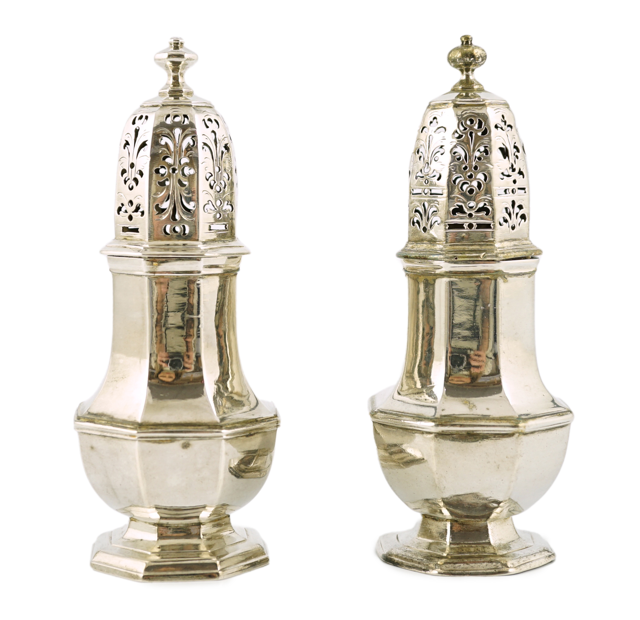 A near pair of George I/George II silver octagonal baluster casters